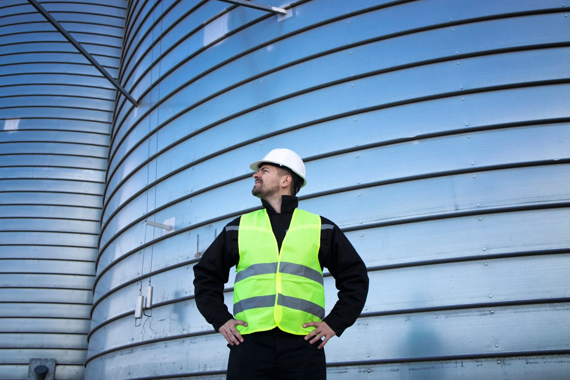 Industrial worker at metal silo storage — metal structures engineering, Planéta Centrum Kft.